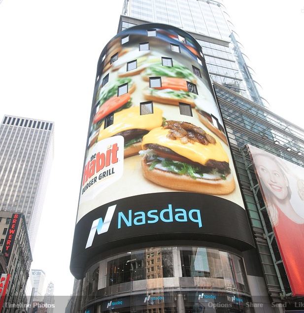 Nasdaq Building with Habit Burger on video screen