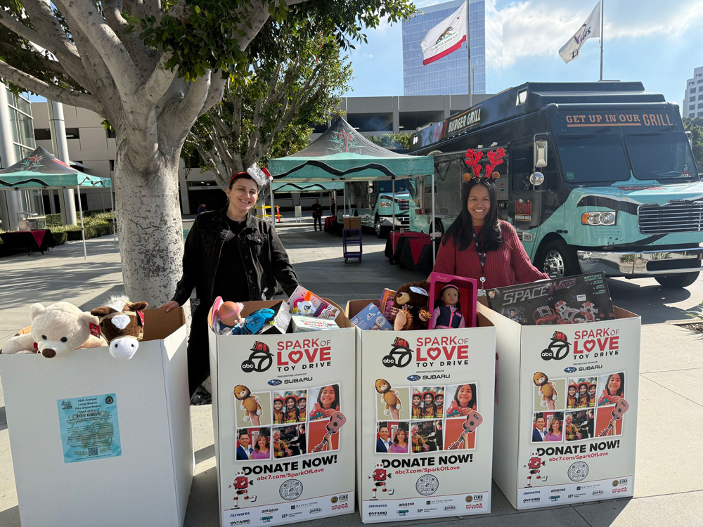 Volunteers and toy bins at the Spark of Love Toy Drive
