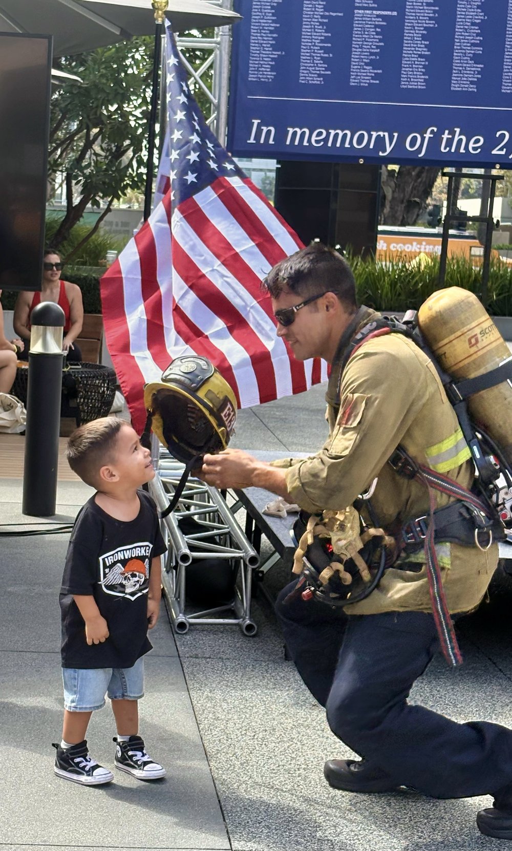 Figherfighter interacting with a child at the Long Beach Fire Department Participants at the Long Beach World Trade Center 9/11 Memorial Stair Climb